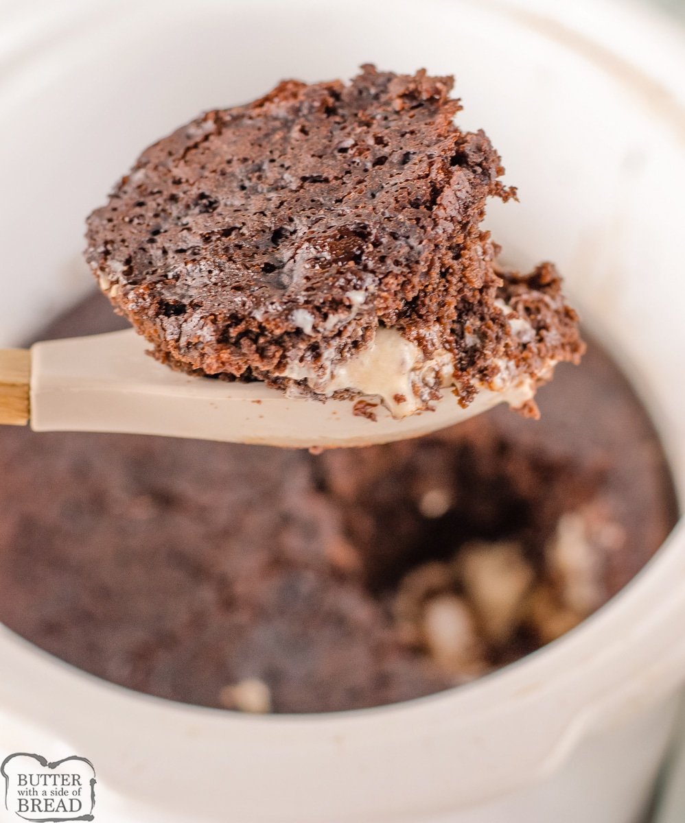 scoop of crockpot lava cake on a wooden spoon
