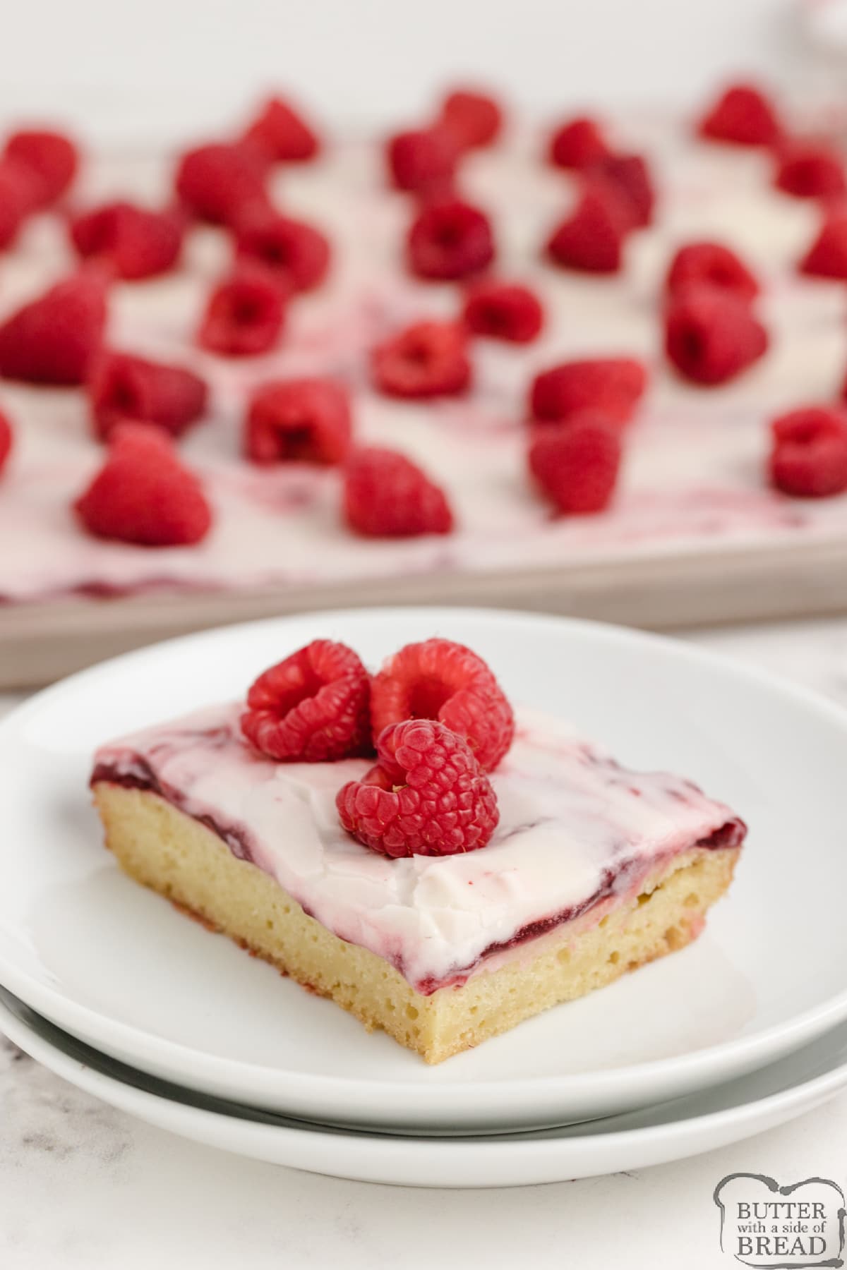 Almond Raspberry Sheet Cake is moist, rich and made completely from scratch. Topped with raspberry pie filling and a creamy almond glaze, this sheet cake is the perfect dessert! 