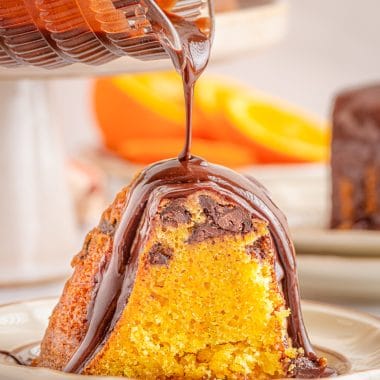 slice of chocolate orange bundt cake drizzled with chocolate