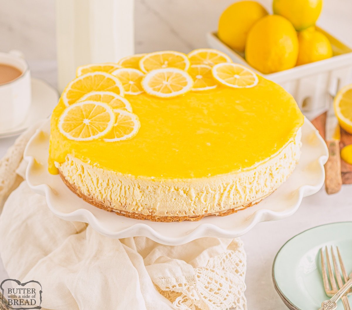 lemon bar cheesecake on a cake pedestal