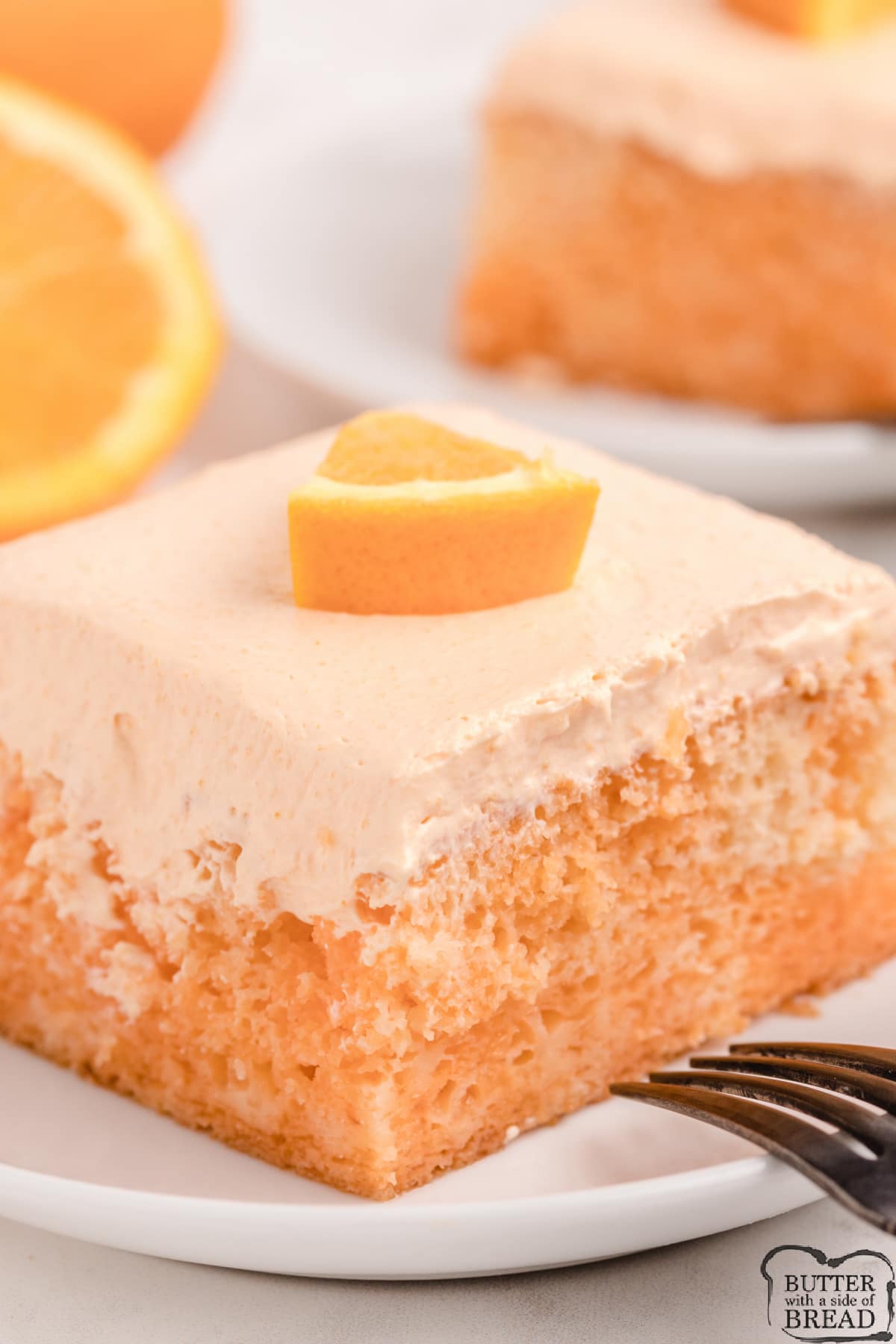 Orange Creamsicle Poke Cake made with a white cake mix, orange soda, orange Jello and vanilla pudding! Fun and fruity cake recipe that is perfect for a crowd! 