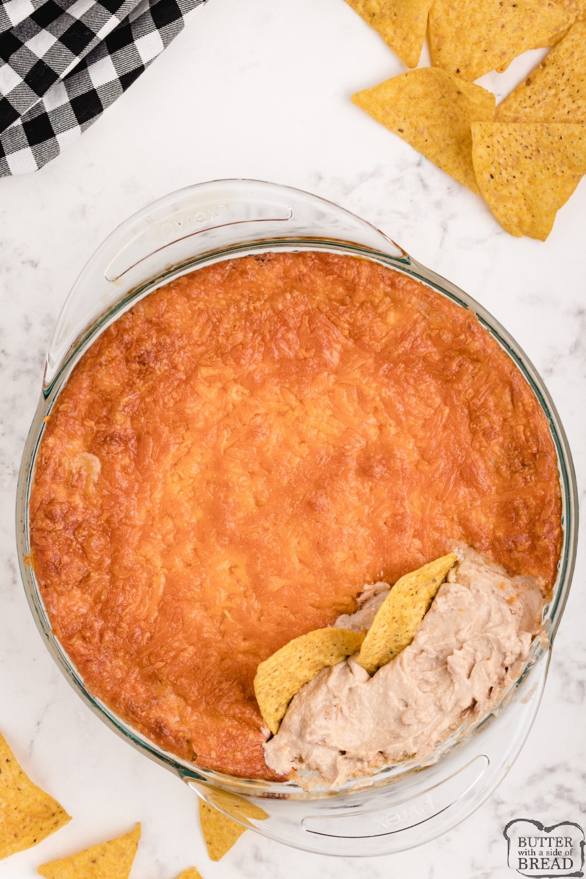 Green Chile Bean Dip is made with just 5 ingredients and is a delicious chip dip! Made with refried beans, cheese, sour cream and salsa, this simple dip is the perfect appetizer. 