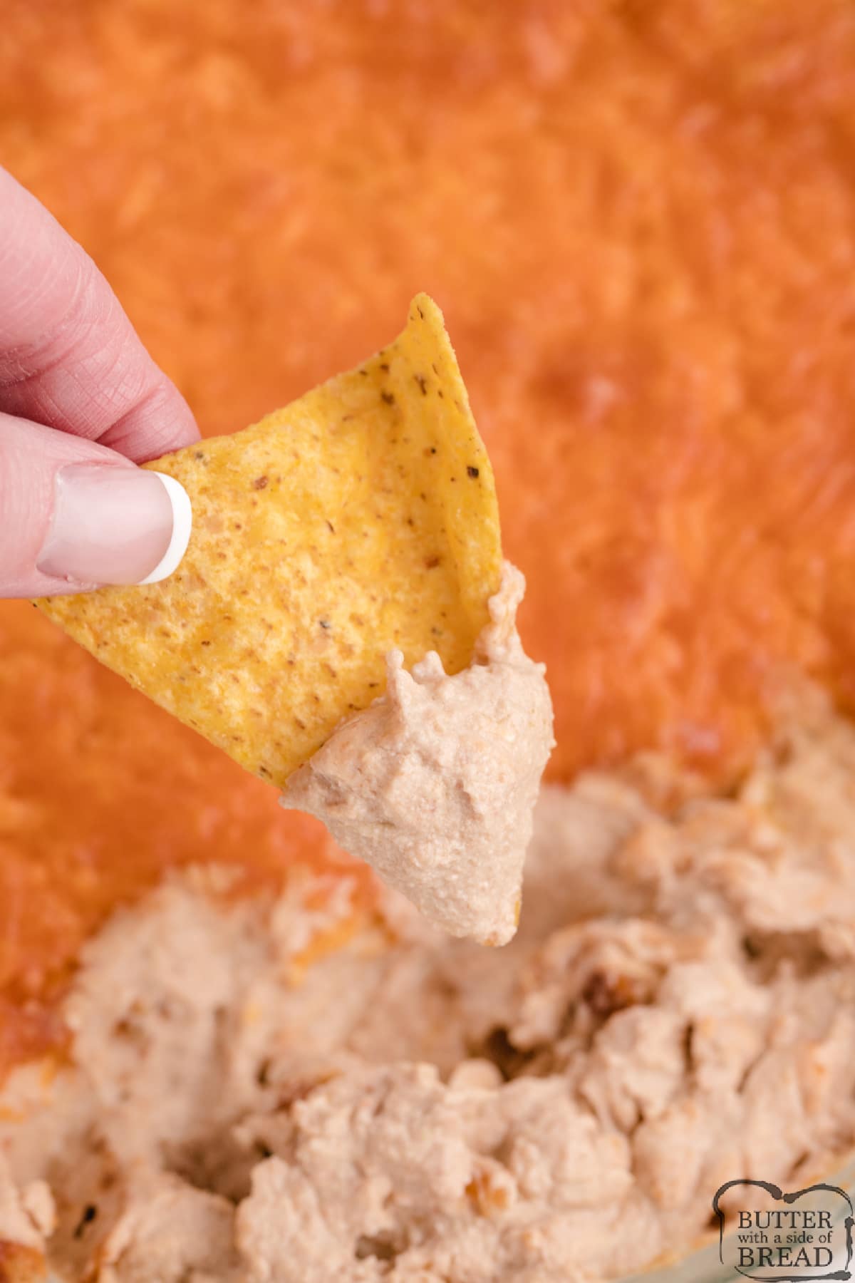 Green Chile Bean Dip is made with just 5 ingredients and is a delicious chip dip! Made with refried beans, cheese, sour cream and salsa, this simple dip is the perfect appetizer. 