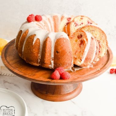 lemon raspberry bundt cake on a wooden cake stand