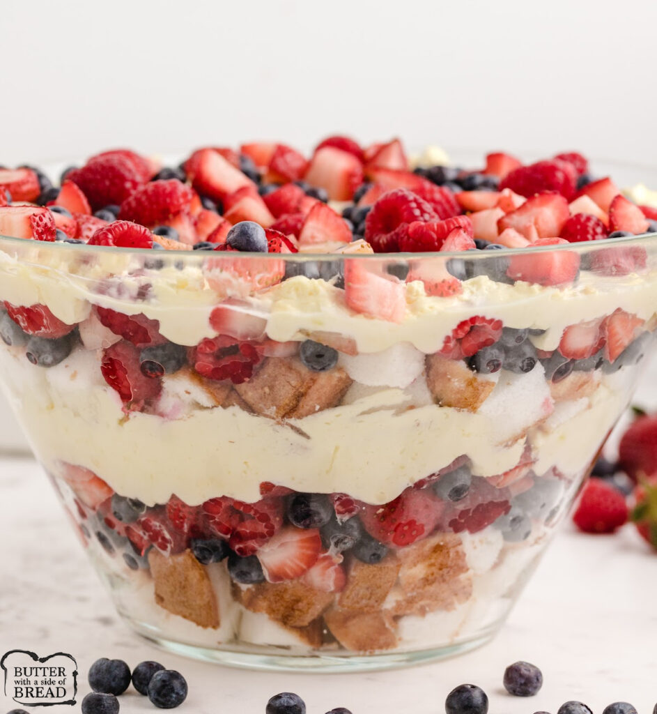 Triple Berry Trifle with angel food cake, fresh berries, sweetened whipped cream, and sour cream is the perfect no-bake dessert for summer gatherings and patriotic holidays.