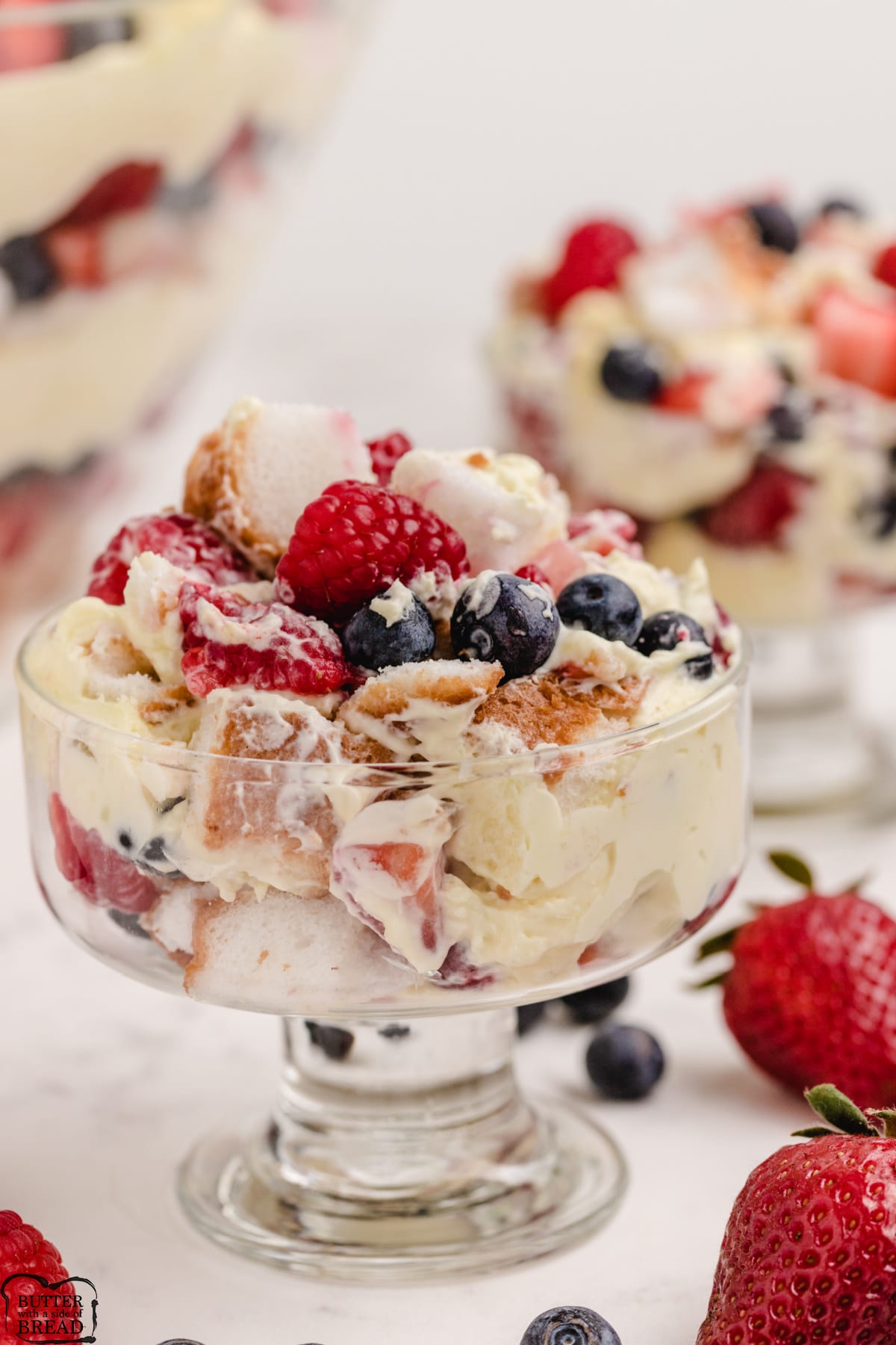 Trifle made with vanilla pudding, whipped cream and three kinds of berries