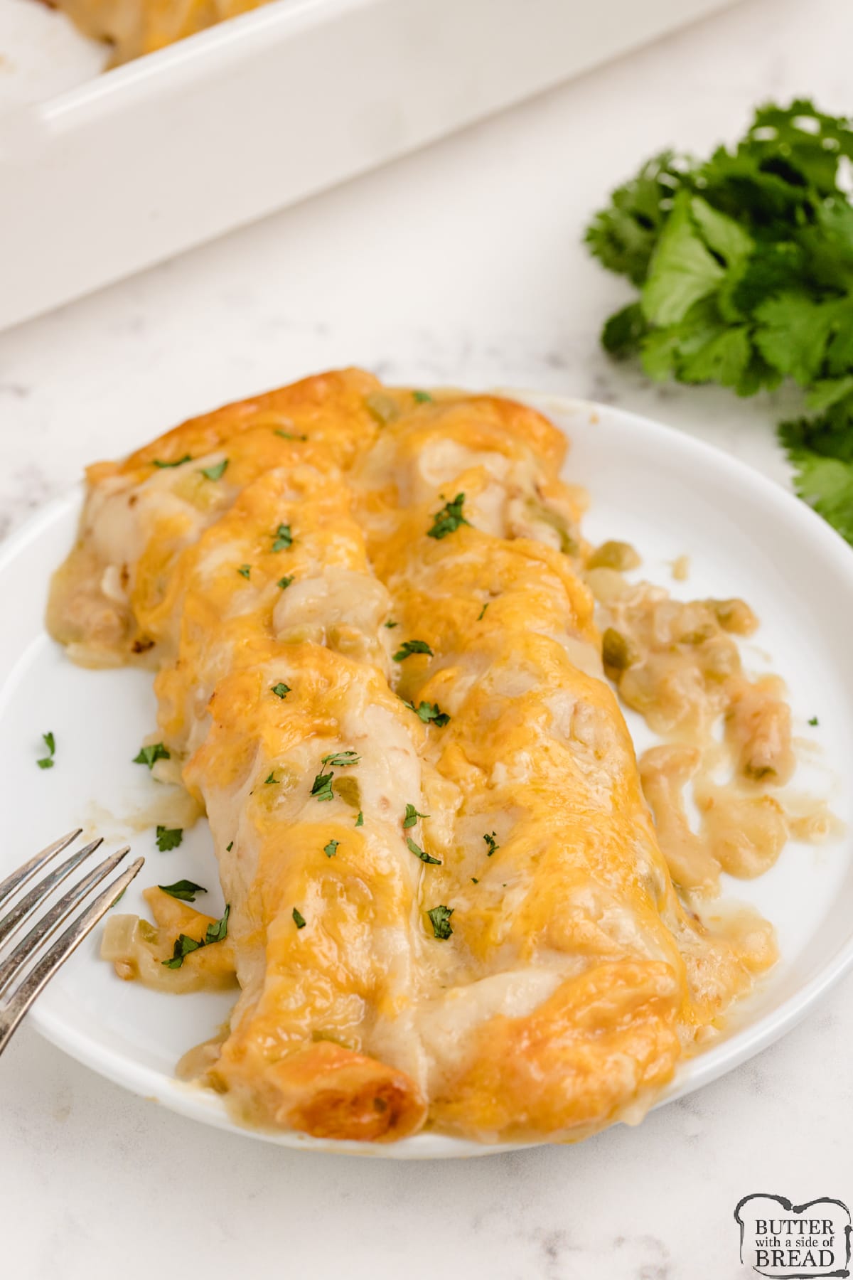 Easy Chicken Enchiladas made completely from scratch with rotisserie chicken for a quick and simple dinner recipe. Our favorite chicken enchilada recipe that is packed with protein and low in fat and carbs too! 