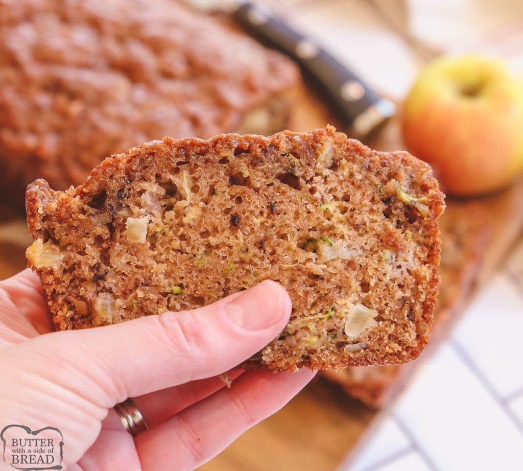 holding a piece of zucchini bread with apples