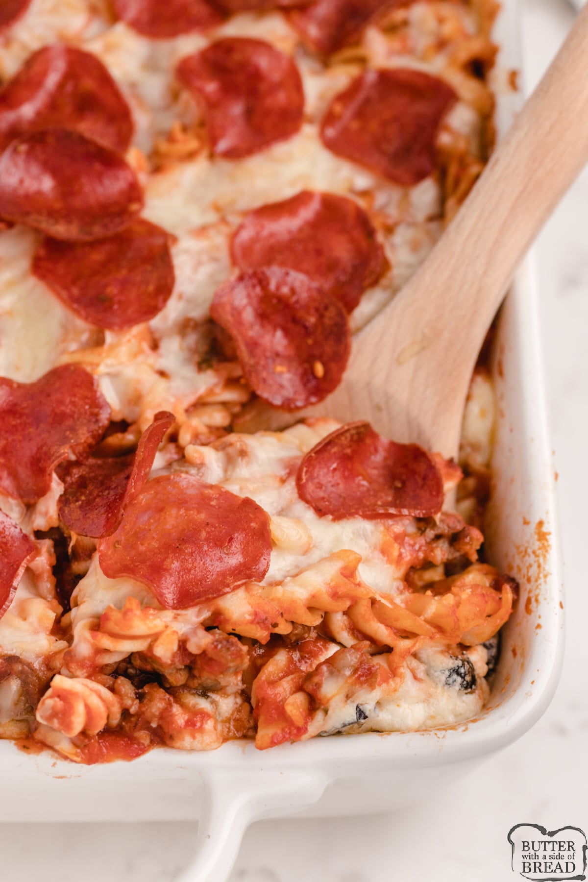 Pizza Pasta Casserole is a dinner recipe that the whole family will love! Simple baked casserole recipe made with rotini, Italian sausage, pepperoni, spaghetti sauce, veggies and cheese. 
