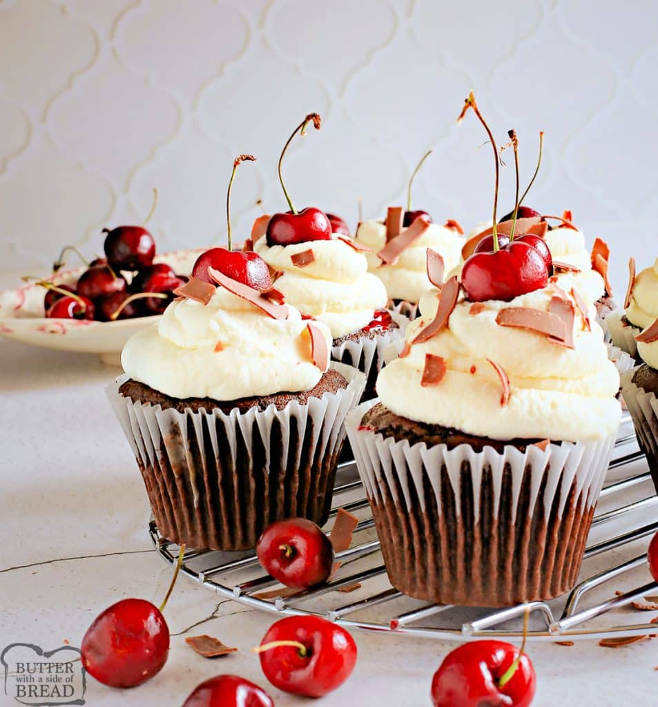 cherry cupcakes topped with sweet cream and chocolate shavings
