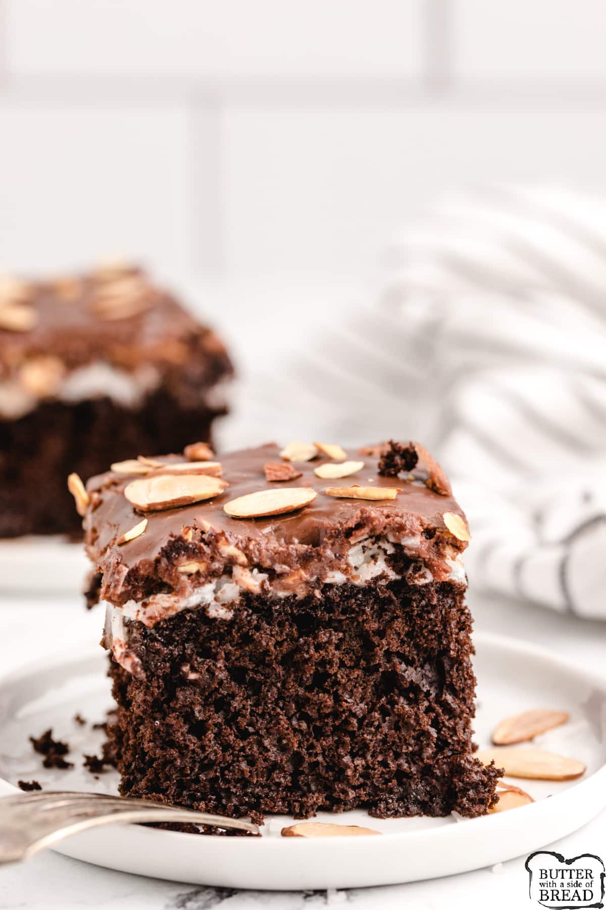 Almond Joy Cake is chocolate cake topped with a marshmallow coconut layer and a chocolate frosting with toasted almonds. Chocolate cake recipe that tastes just like your favorite Almond Joy candy bar! 