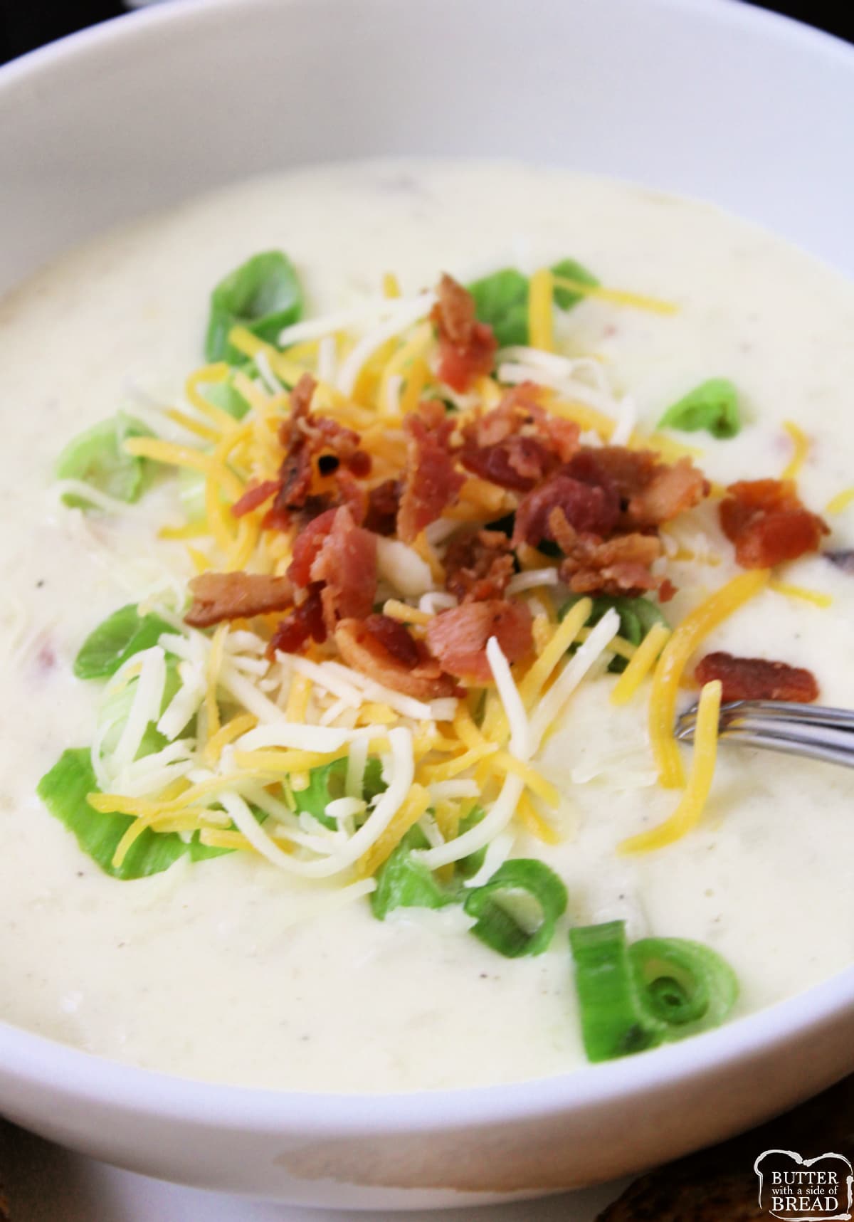 Bowl of potato soup with cheese and bacon