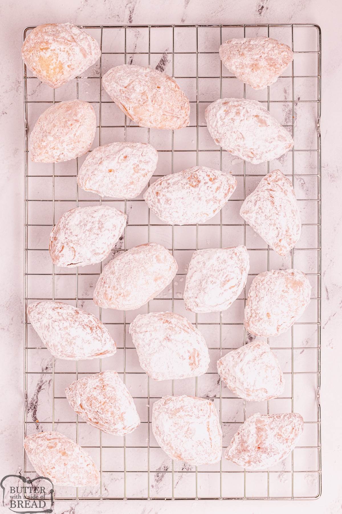 batch of fried biscuit beignets cooling