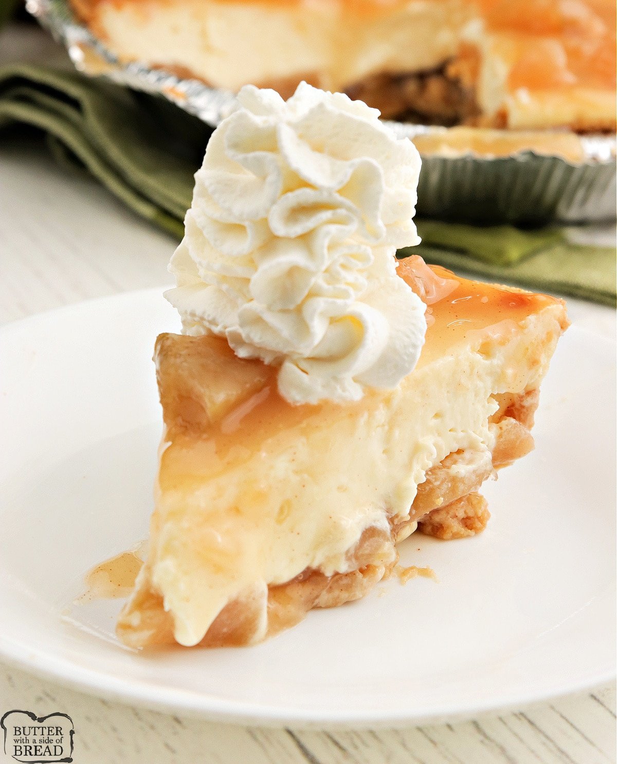 Caramel Apple Cheesecake made with apple pie filling, a graham cracker crust and caramel topping. Simple cheesecake recipe that is perfect for fall! 
