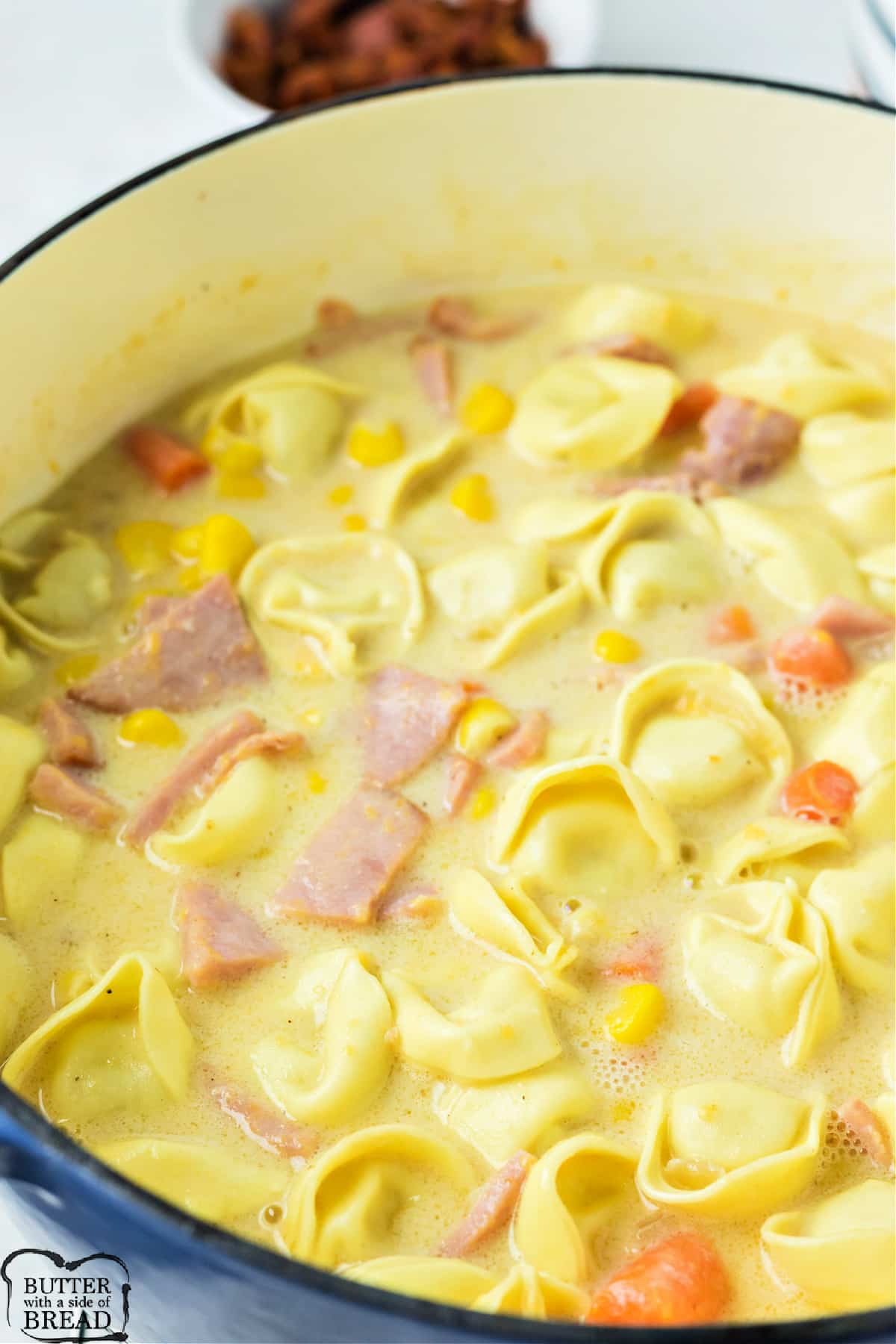 Soup with pasta, ham, carrots, corn and cheese