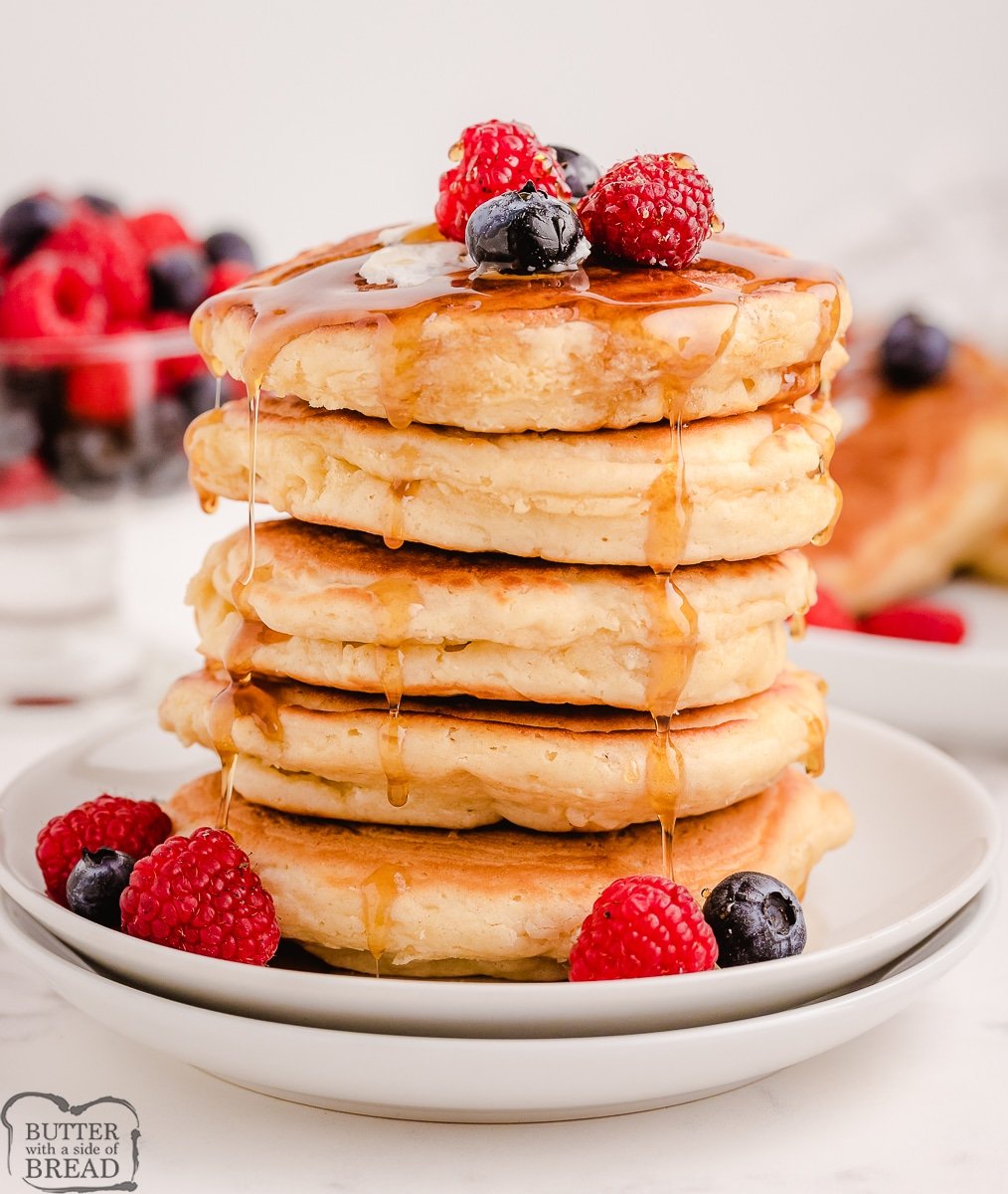 stack of homemade pancakes with berries and syrup