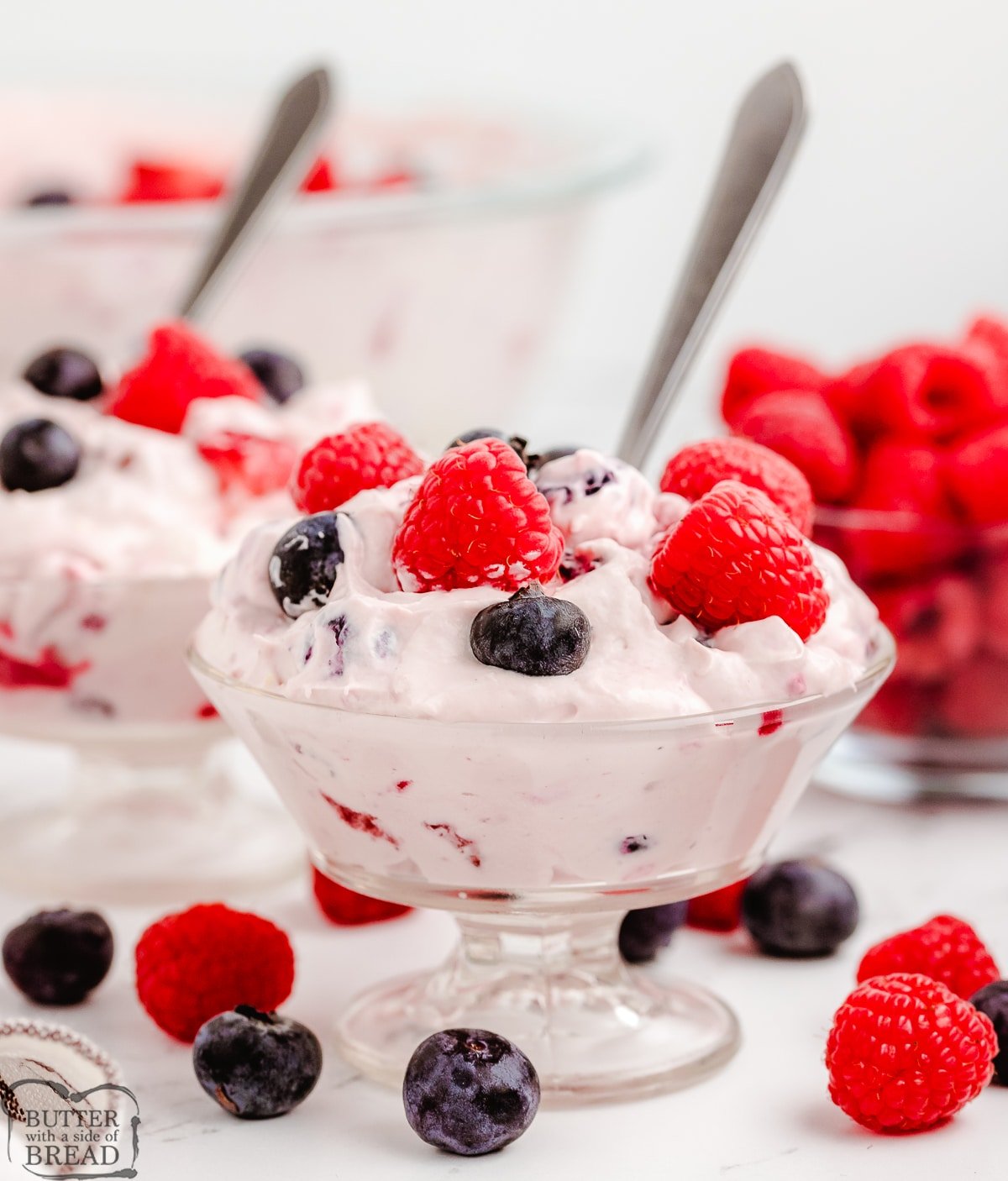 berries and cream salad with a spoon