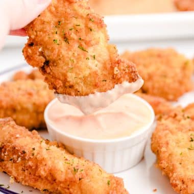 dipping homemade chicken tenders in fry sauce