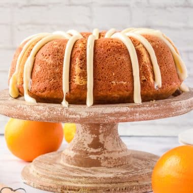 orange bundt cake on a cake pedestal