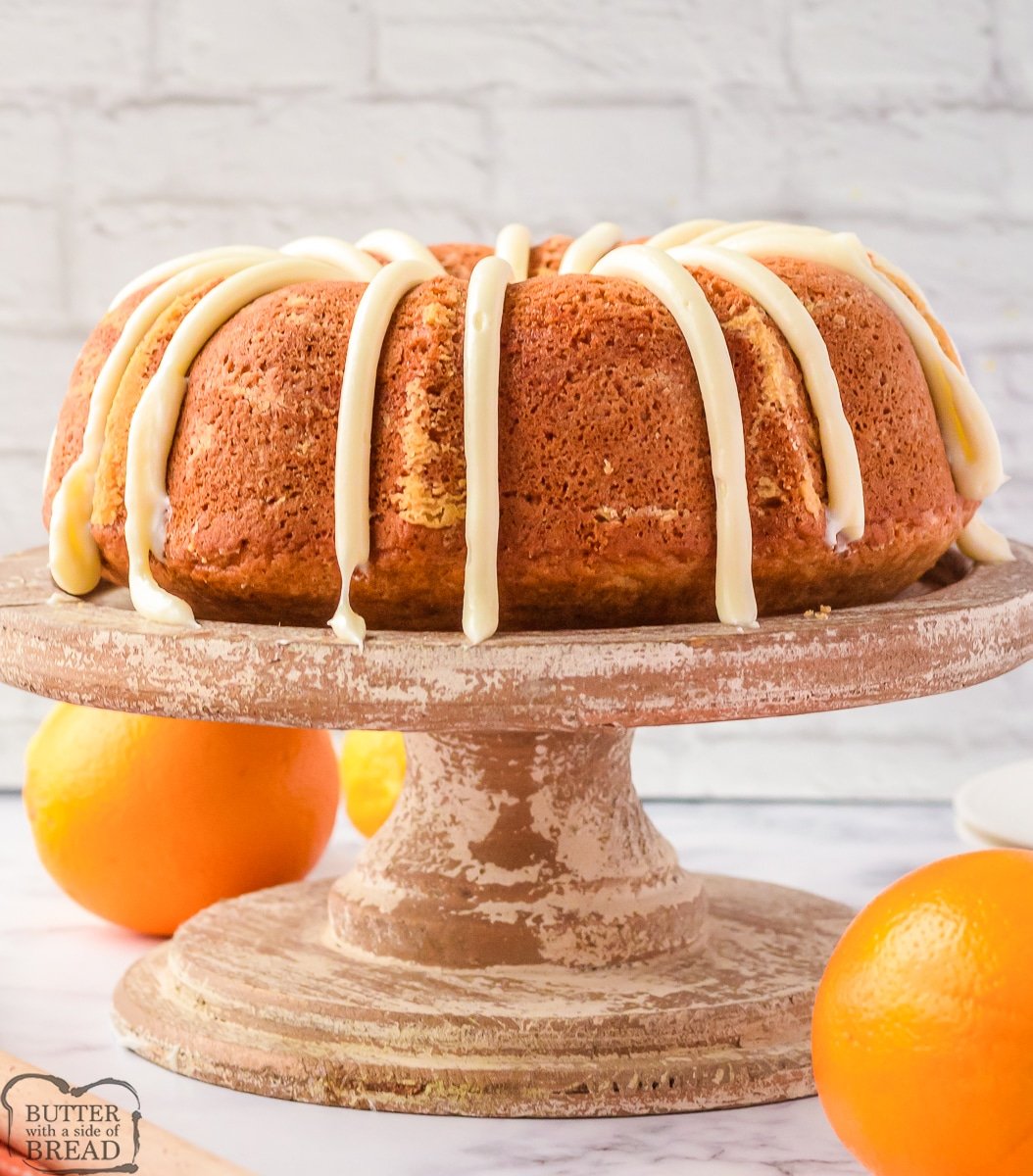 orange bundt cake on a cake pedestal