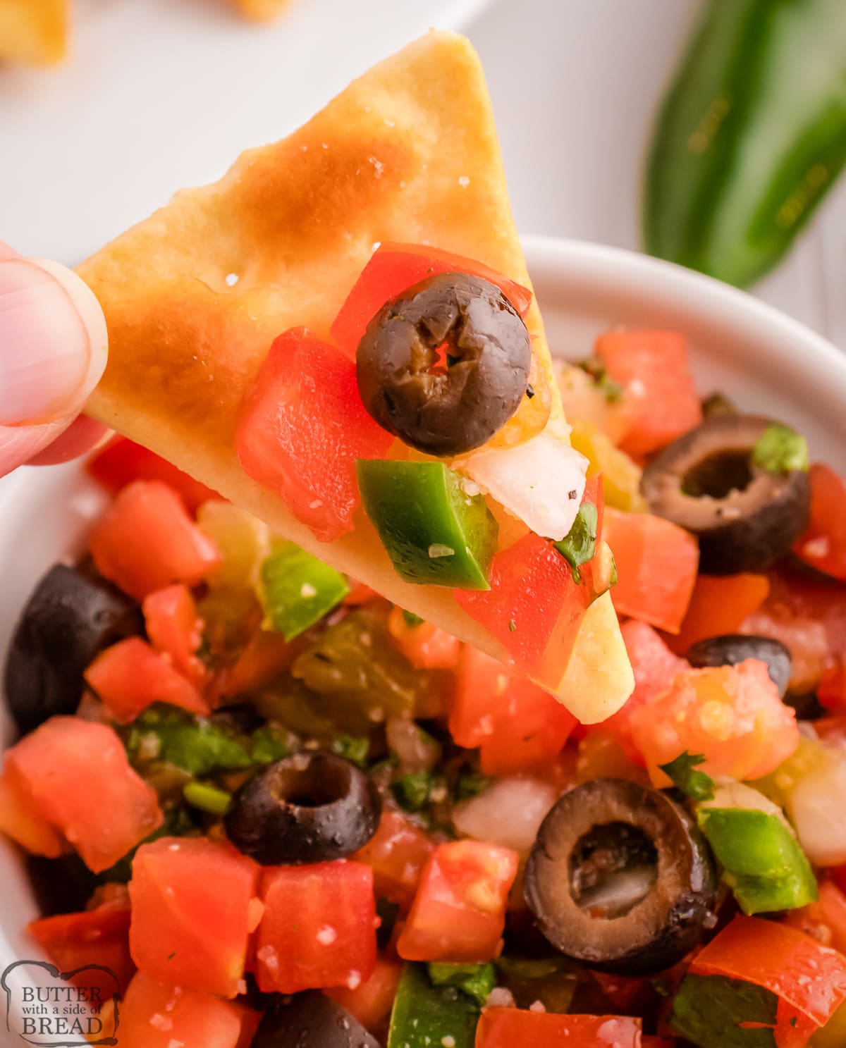salsa with olives on a chip