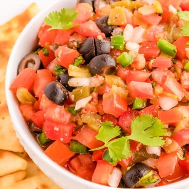 fresh salsa with olives in a white bowl