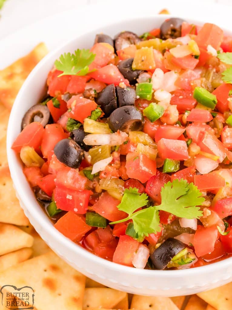 fresh salsa with olives in a white bowl