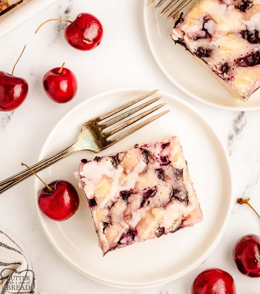 cherry butter cake on a white plate with fresh cherries