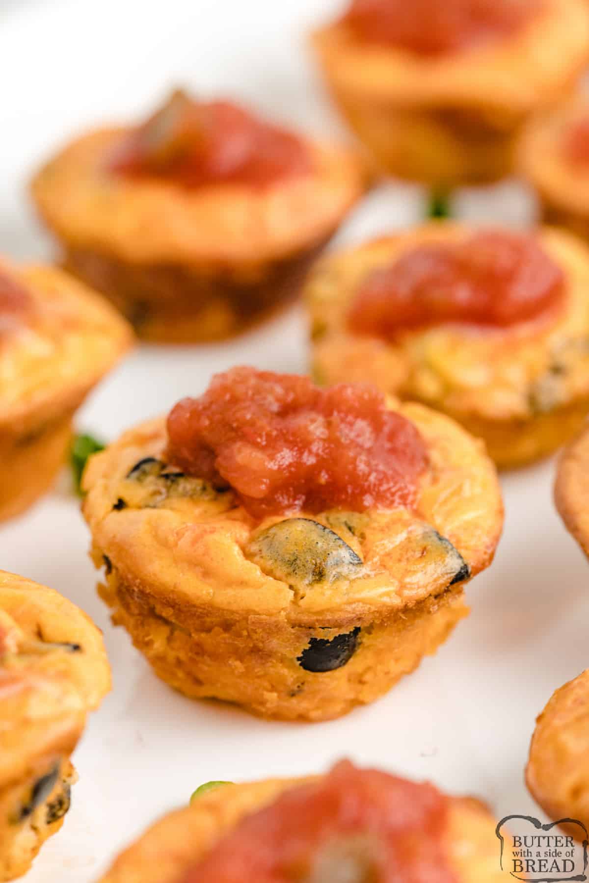 Easy Salsa Bites are a simple, gluten free appetizer made with cream cheese, salsa, eggs and cheese. Cheesy and perfectly portioned, these little bites make great snacks and are easy to take to a party!