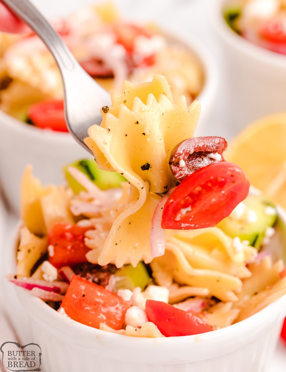 forkful of Greek pasta salad with cherry tomatoes