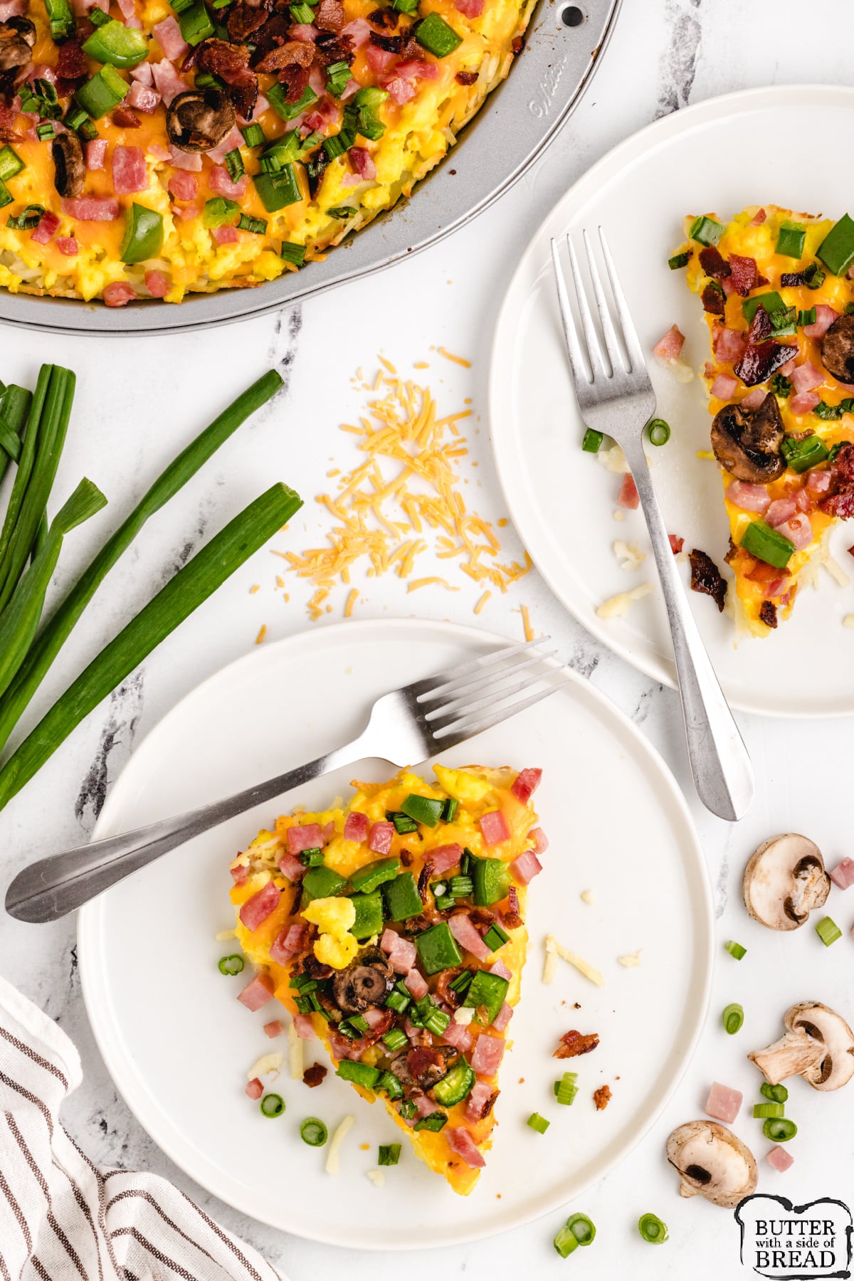 Hash Brown Breakfast Pizza made with a hash brown crust, scrambled eggs, diced ham, cheese and any other toppings you'd like! Delicious breakfast pizza recipe you can serve for breakfast, lunch or dinner!