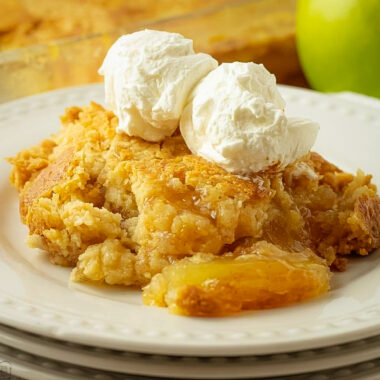 buttery apple dump cake with a scoop of vanilla ice cream on top