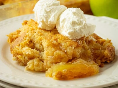 buttery apple dump cake with a scoop of vanilla ice cream on top