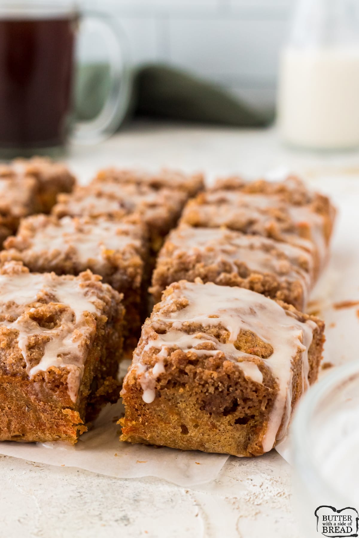Carrot Cake Coffee Cake is a delicious way to enjoy breakfast! This soft, moist coffee cake recipe is loaded with shredded carrots, chopped walnuts and then topped with a crumbly topping and a simple powdered sugar glaze. 