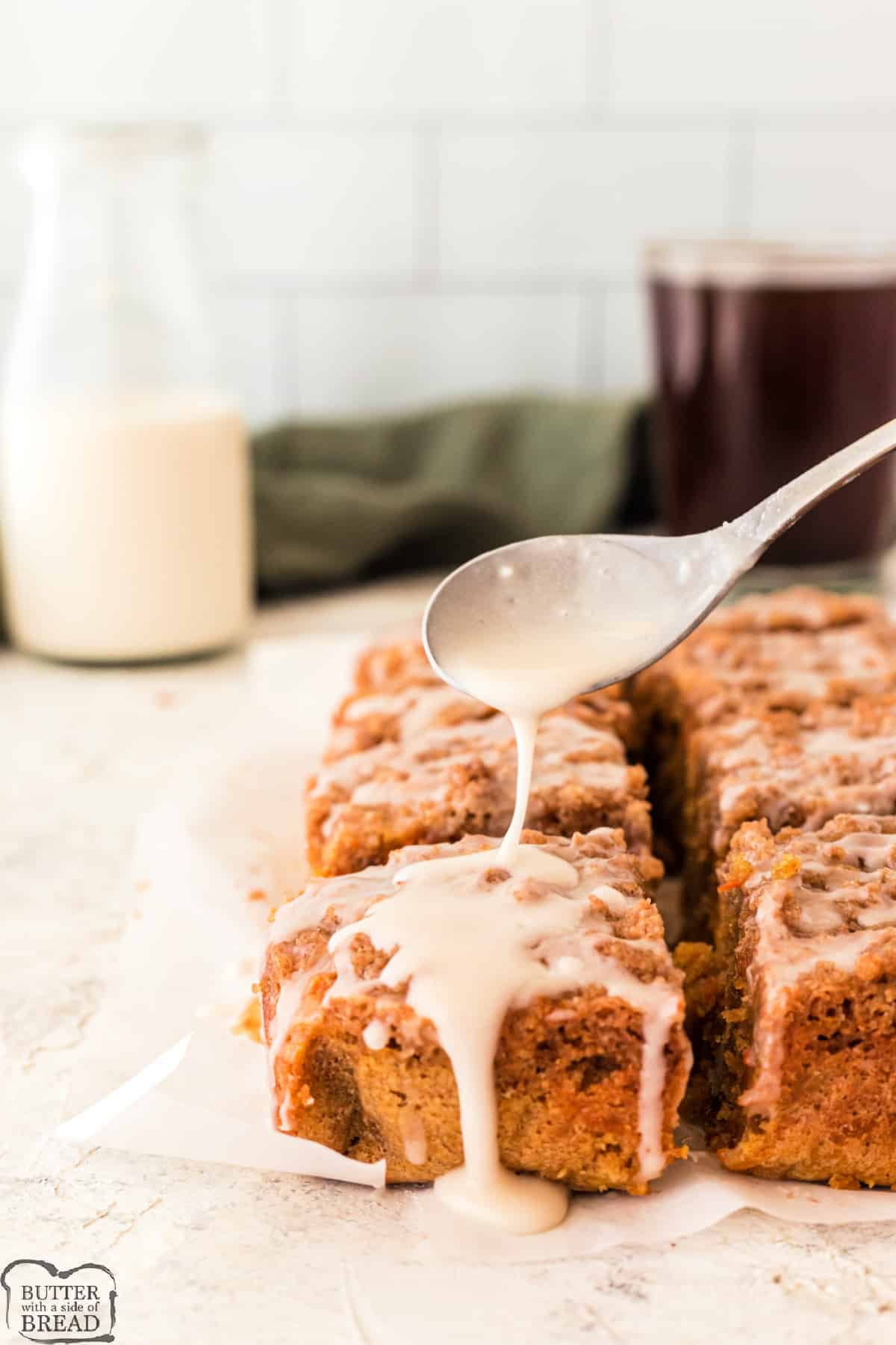 Carrot Cake Coffee Cake is a delicious way to enjoy breakfast! This soft, moist coffee cake recipe is loaded with shredded carrots, chopped walnuts and then topped with a crumbly topping and a simple powdered sugar glaze. 