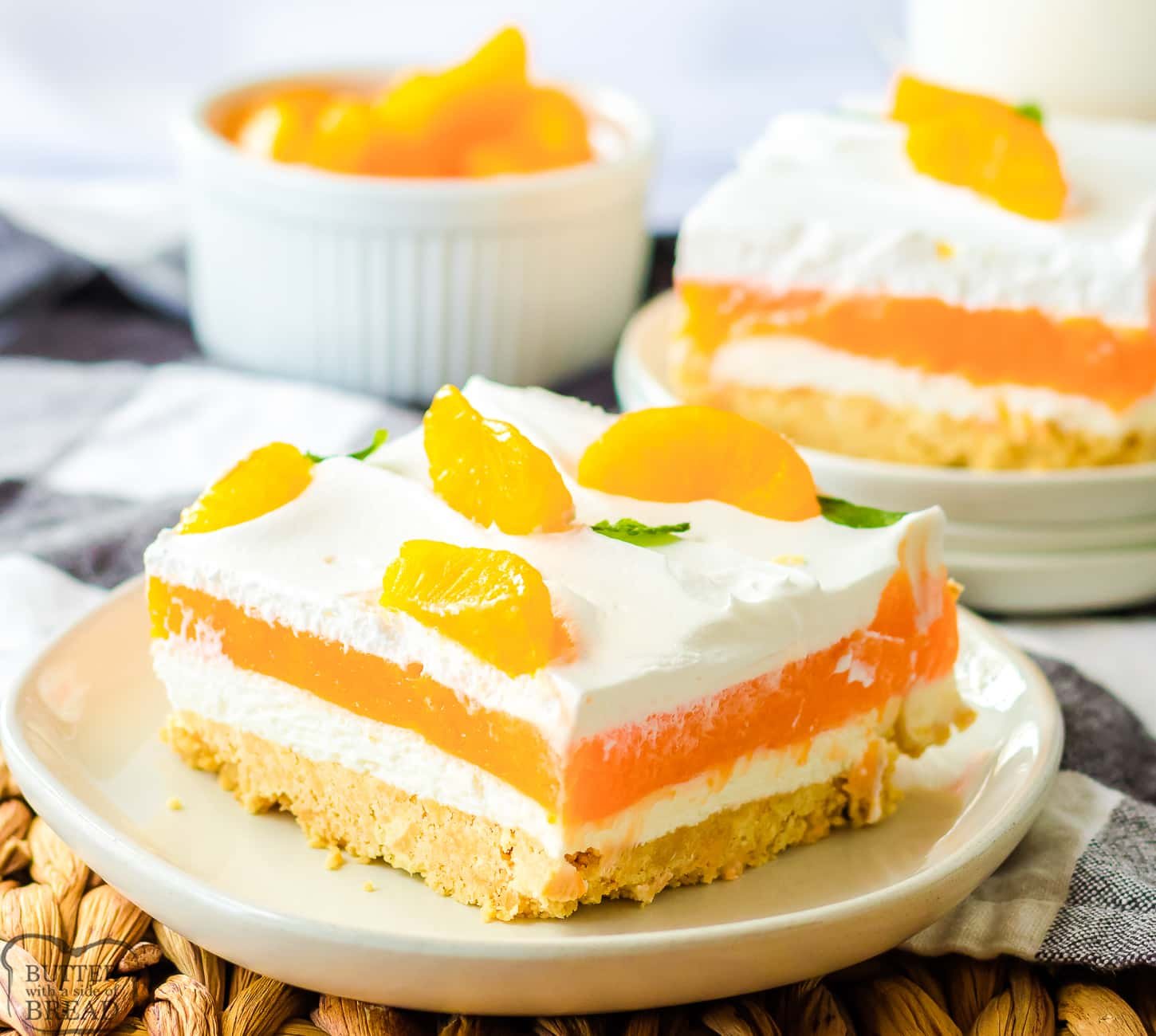 orange lush dessert with layers of jello and cream