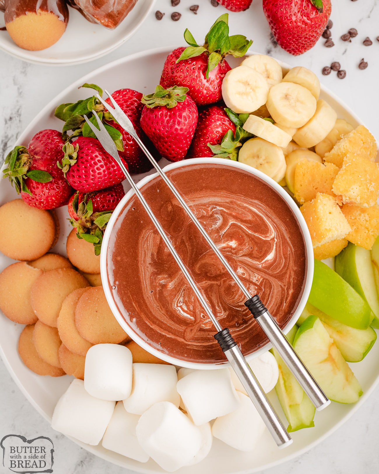tray with marshmallow fondue and fruits for dipping