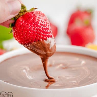 dipping a strawberry in chocolate marshmallow fondue