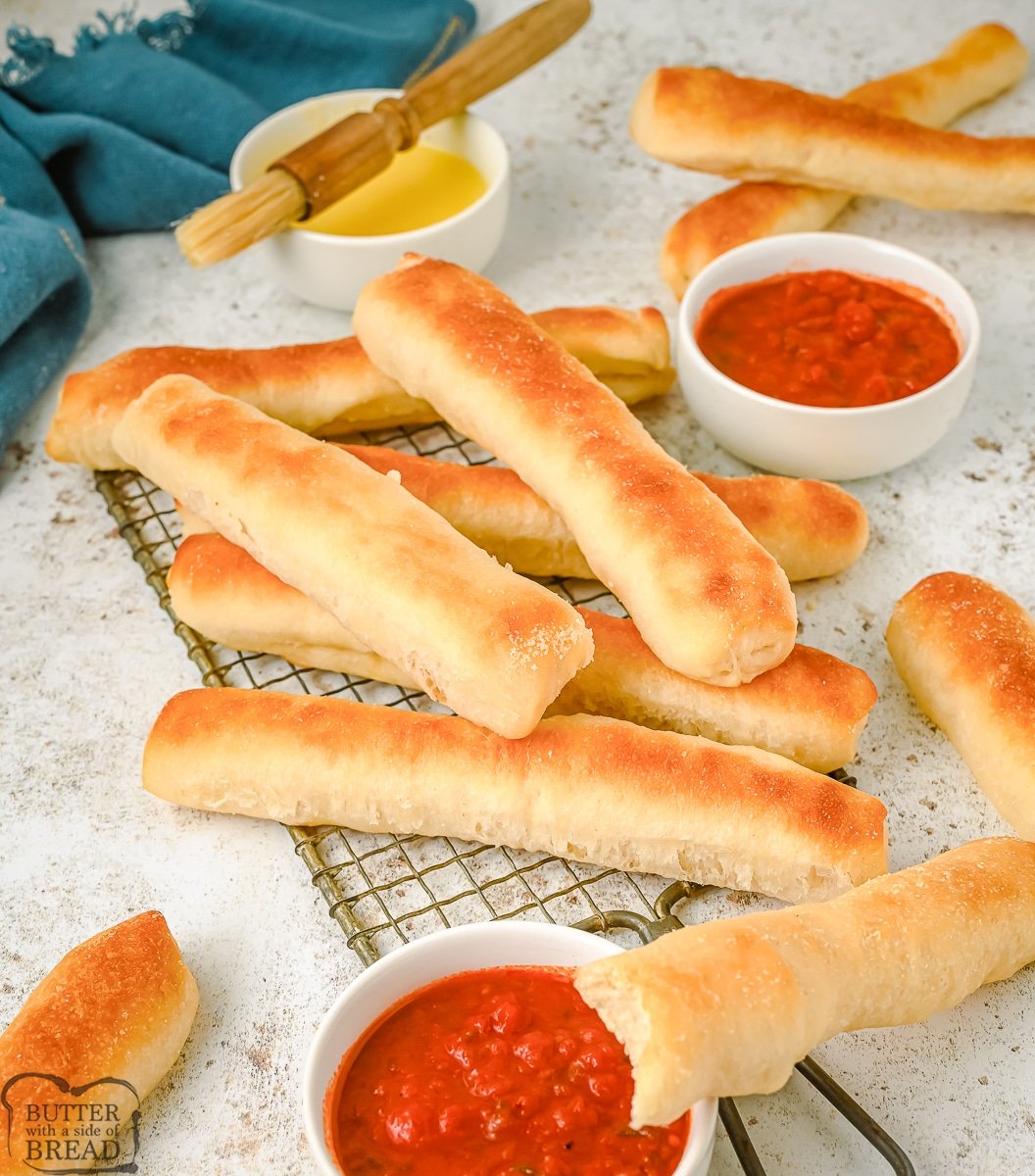 breadsticks on a cooling rack brushed with butter