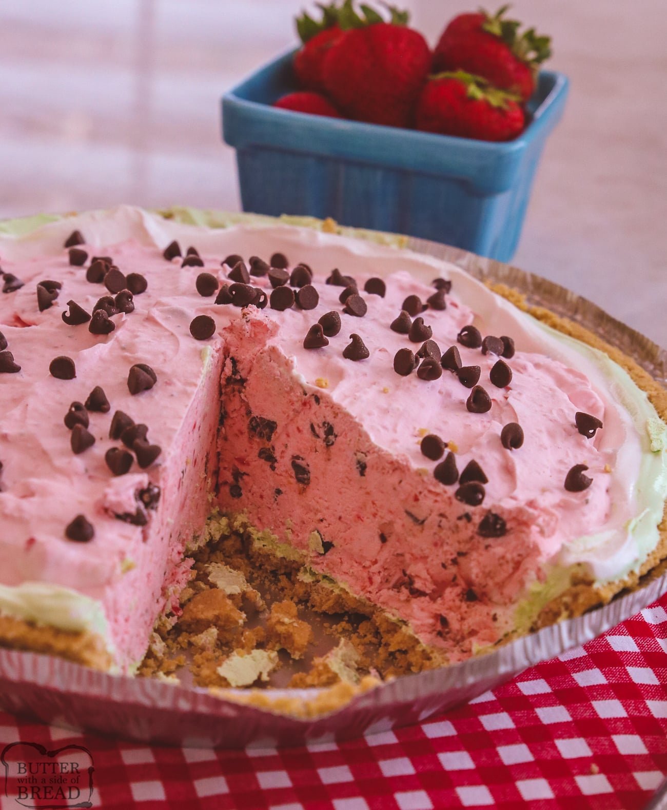 slice cut out of a strawberry watermelon cream pie