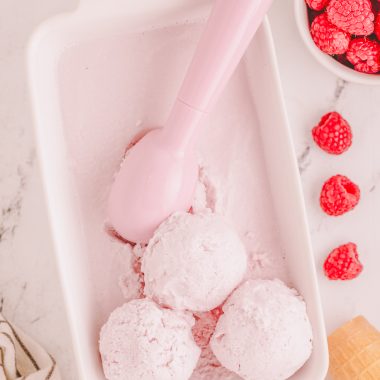 easy 3 ingredient raspberry sherbet scooped out of a bread pan