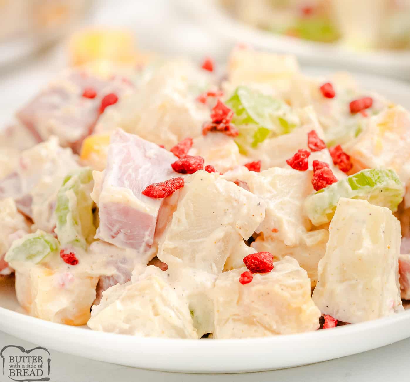 plateful of potato salad with ham and cheese