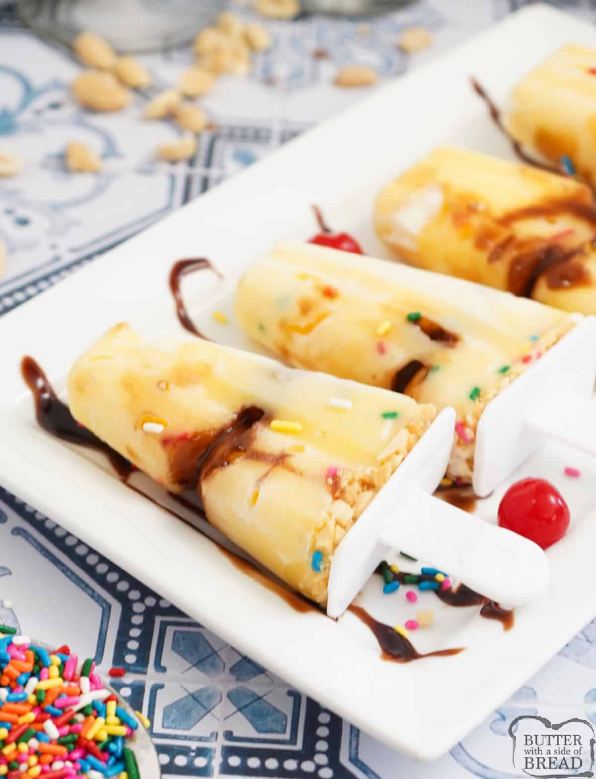 Hot Fudge Sundae Pudding Pops are made with vanilla pudding, hot fudge, sprinkles and peanuts. Layer the ingredients in a popsicle mold for a delicious frozen treat!