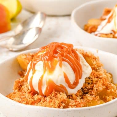 apple brown betty dessert with ice cream and caramel topping