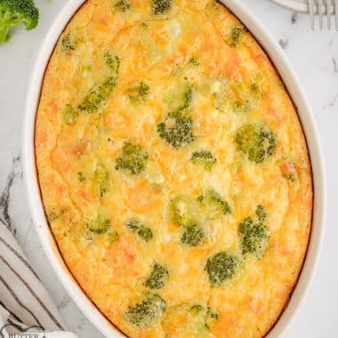 broccoli cheddar casserole topped with cheese