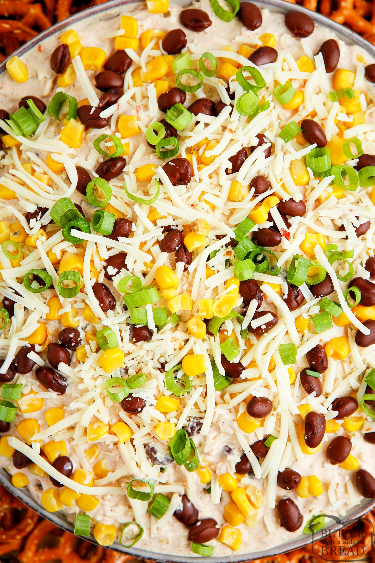 Chip dip made with cream cheese, sour cream, cheese, black beans and corn