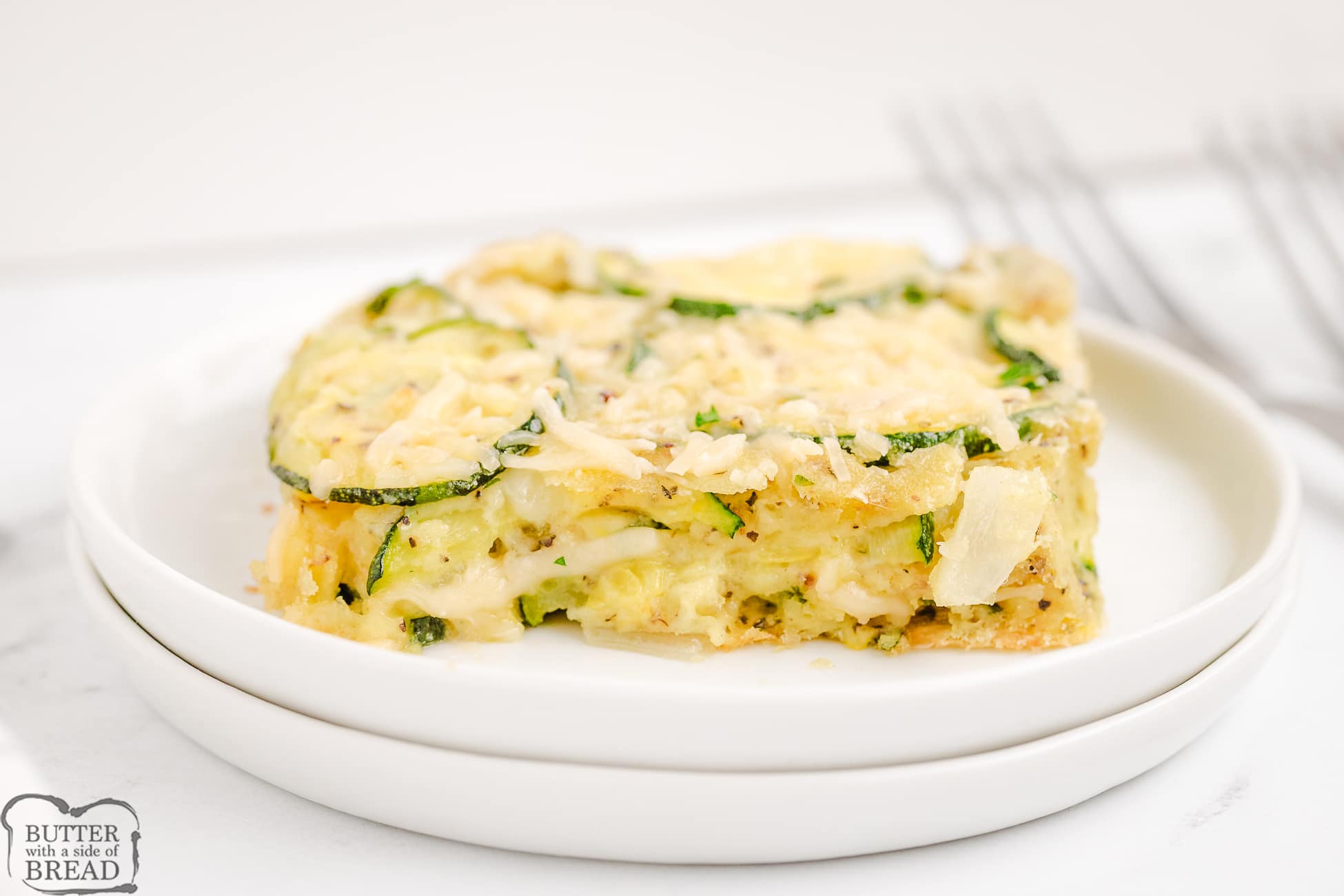 piece of baked zucchini casserole with Parmesan cheese