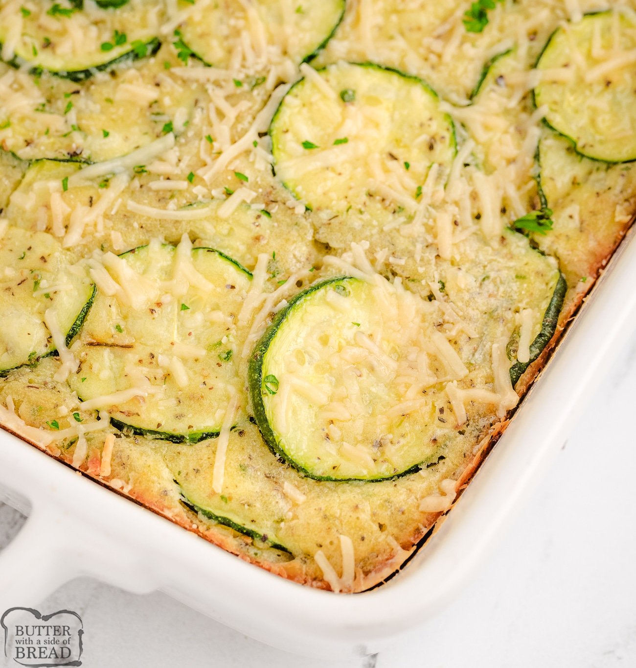 baked zucchini Parmesan casserole in a white baking dish