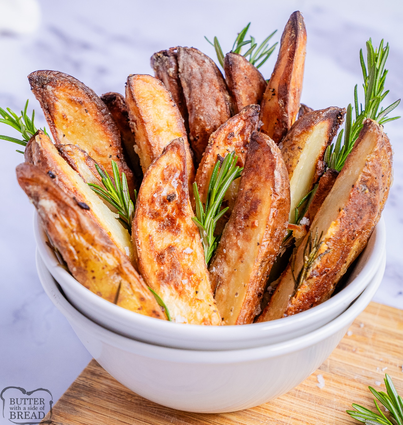 bowl of roasted potatoes with fresh rosemary