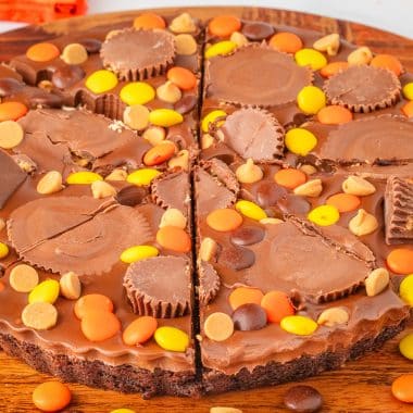 Reese's brownie dessert pizza topped with peanut butter fudge ganache
